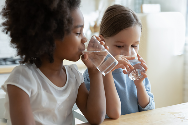 two little girls drinking water